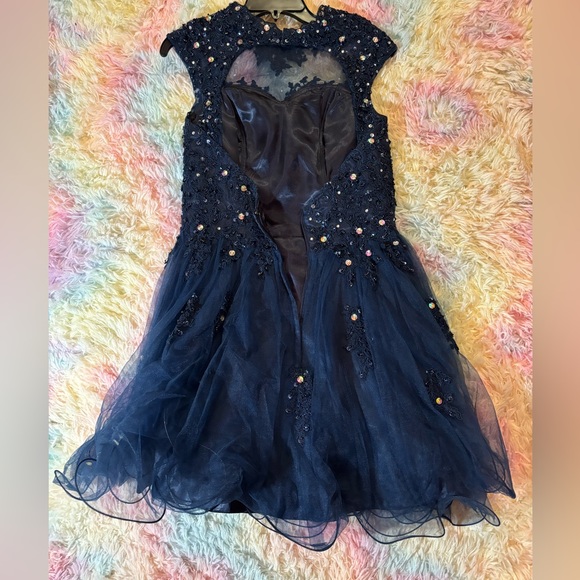Dark blue prom dress. Zip back. Size 4. Sequin tops. Sheer bottom. Wore once. - Picture 3 of 3